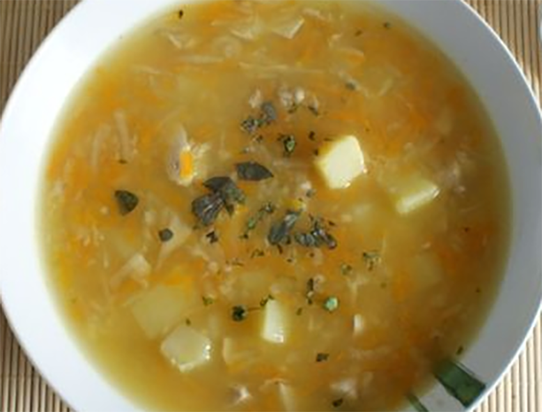 Polish whey, millet and potato soup served in a soup bowl