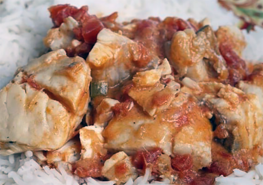 grouper and cassava stew cooked in coconut milk and tomato on a bed of rice
