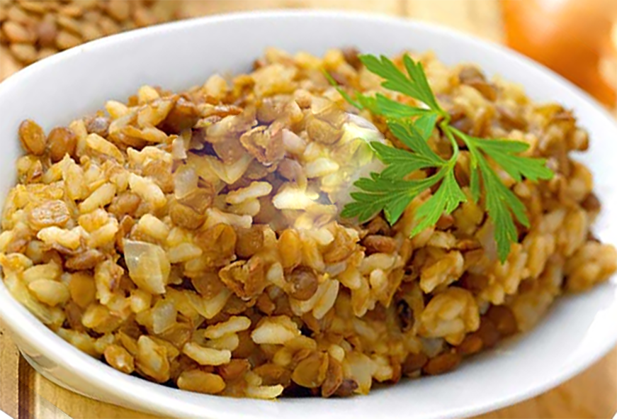lentil and rice pilaff in a bowl garnished with a sprig of parsley