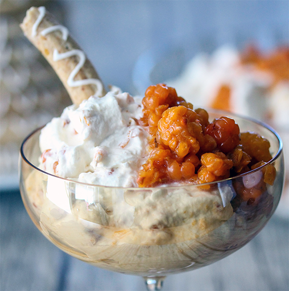 cloudberries served with whipped cream in a glass