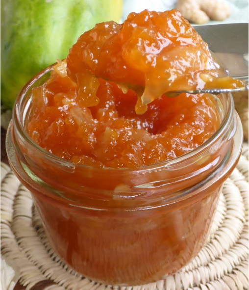 papaya chutney lifted from a glass jar with a spoon