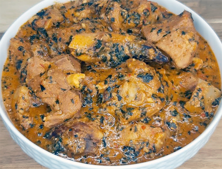 Nigerian groundnut (peanut) soup made with chicken served in a white bowl
