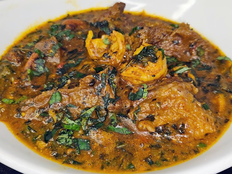 ogbono soup with waterleaf served in a white bowl