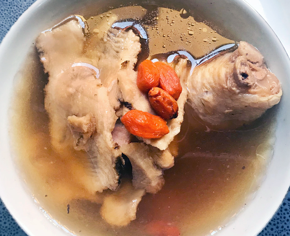 Oriental-style chicken with angelica root, ginseng and goji berries served in a bowl