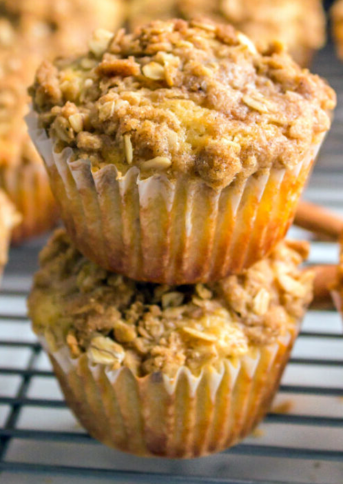 two parmesan cheese and oatmeal muffins stacked on a wire rack
