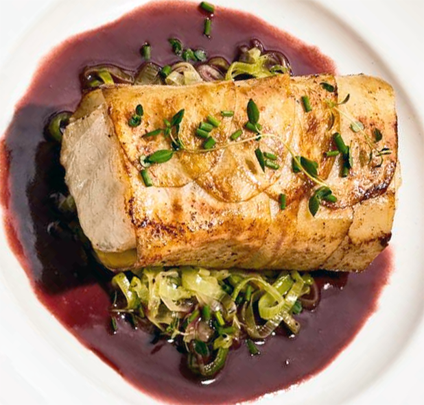 sea bass fried in a potato wrap served on a bed of leeks in a red wine sauce
