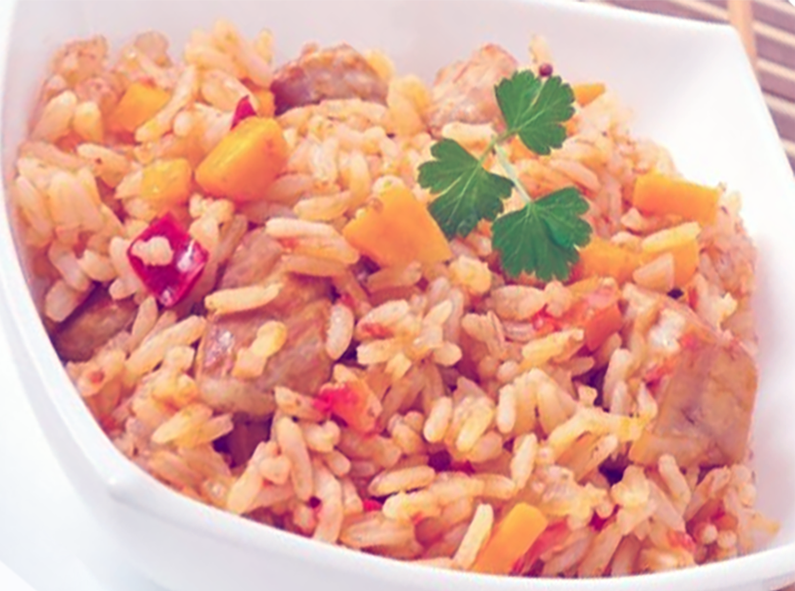 rice pilaff with tomatoes in a white bowl