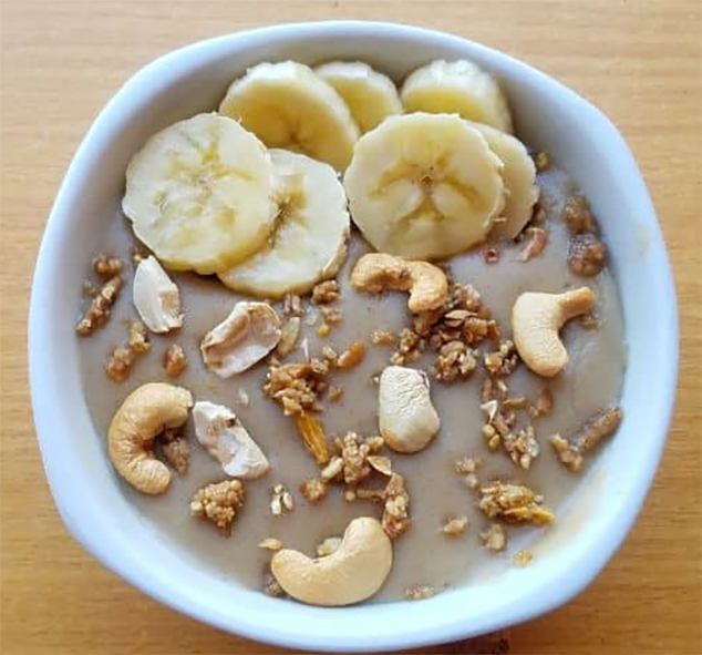 boiled and mashed tiger nuts in a bowl with banana and cashews