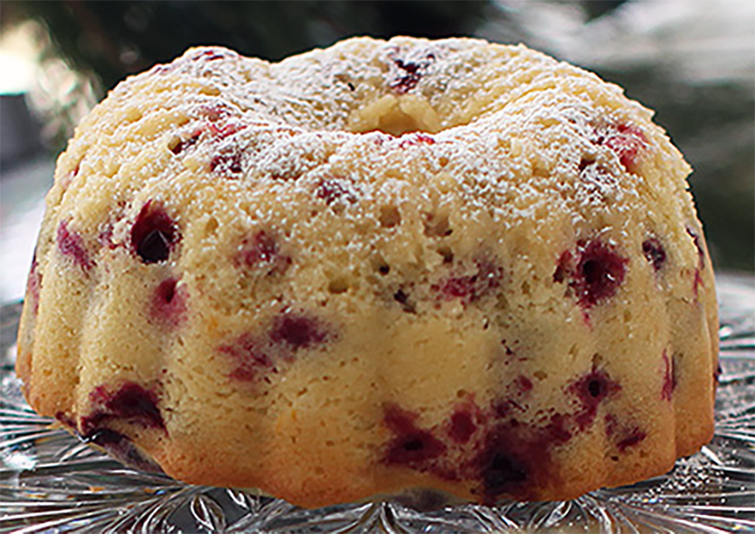 Steamed cranberry pudding presented on a cake stand