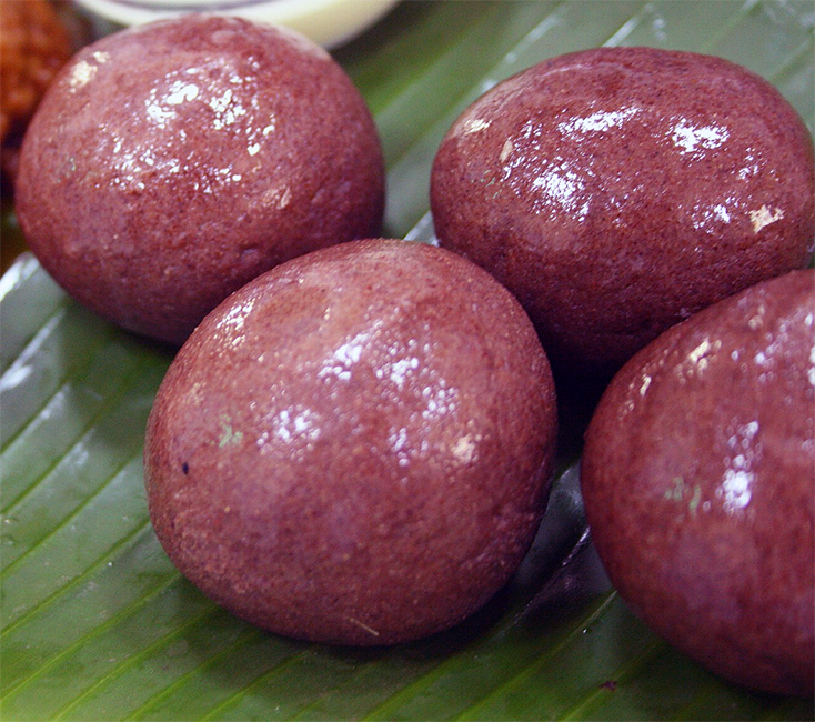 balls of ragi mudde served on a banana leaf