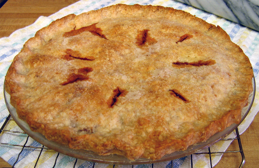 red berry pie with oat crust cooling on a wire rack