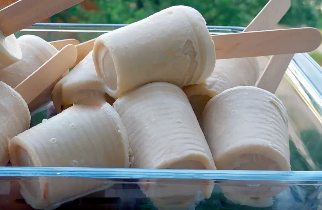 pile of ripe plantain ice cream set in cups and with sticks coming out the base