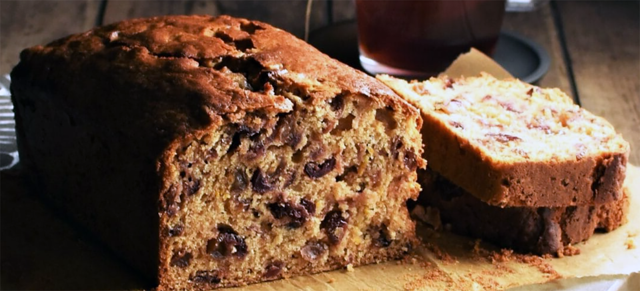 rooibos tea loaf with slices on a piece of baking parchment
