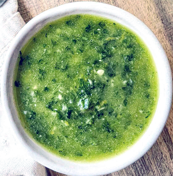 whisked herby salmoriglio sauce in a white bowl