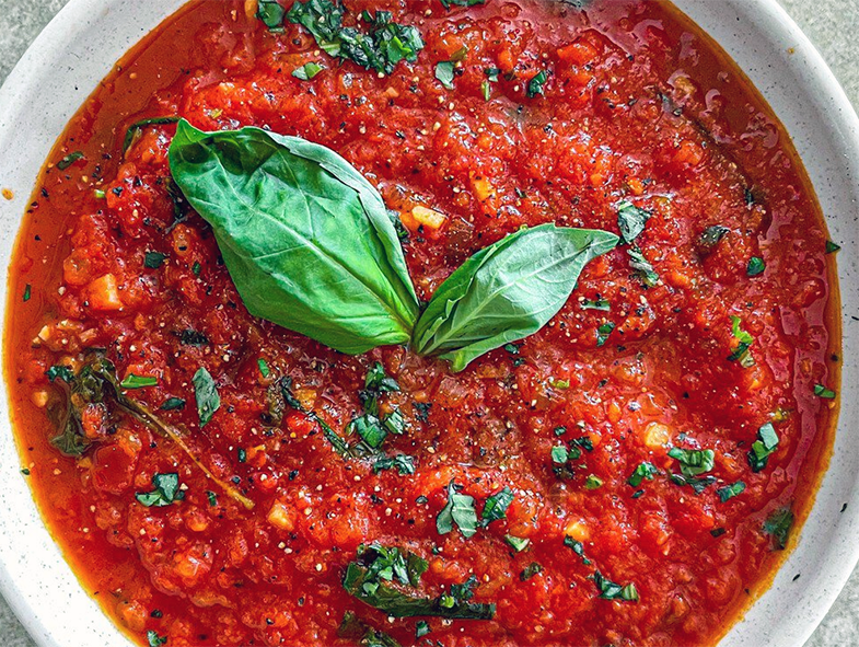 fresg tomato and basil sauce in a ramekin with a basil sprig garnish