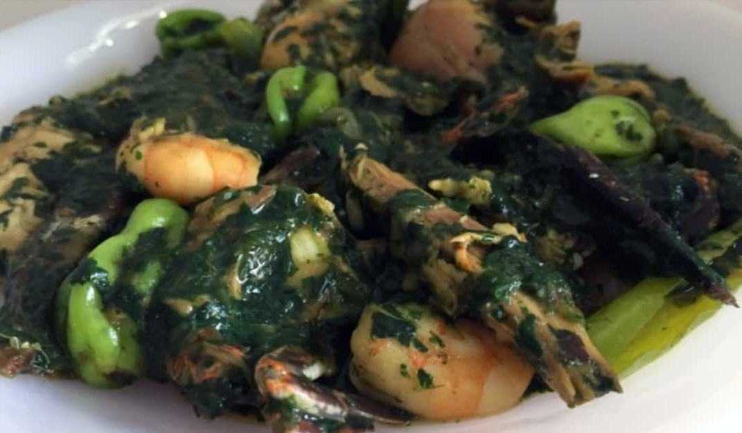 Togolese sauce of greens with seafood served on a plate