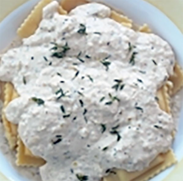 white fennel sauce served on a bed of pasta squares