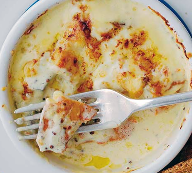 Scottish kippers in a cream sauce with a flake of kipper raised on a fork