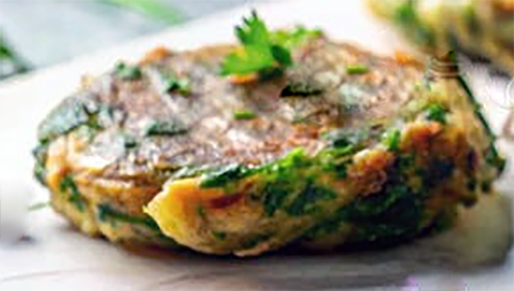 sea aster fritter on a plate garnished with a flat-leaf parsley leaf