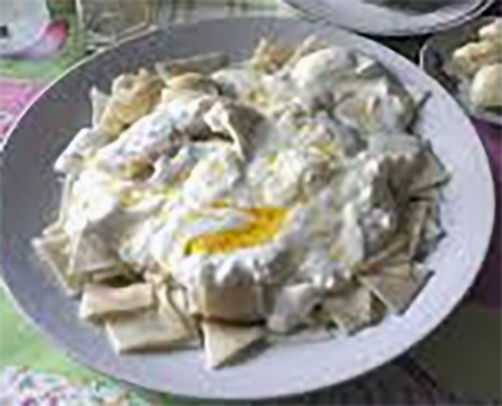 Armenian serim, baked dough with topped with yoghurt and garnished with honey