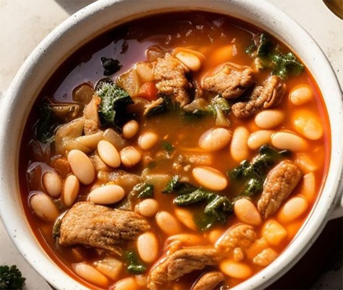 white bean and meat stew in a soup bowl