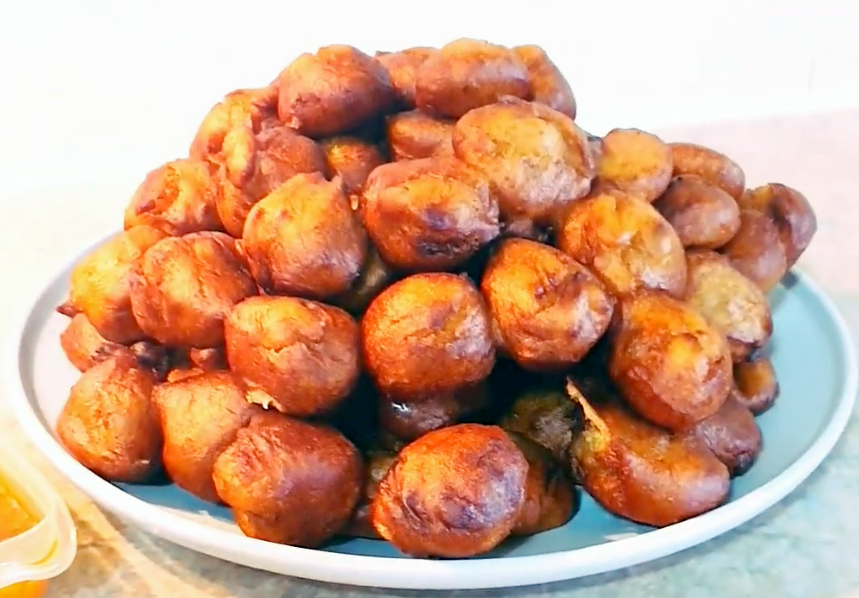 rice akara fritters of banana and rice flour served piled in a pyramid on a blue plate