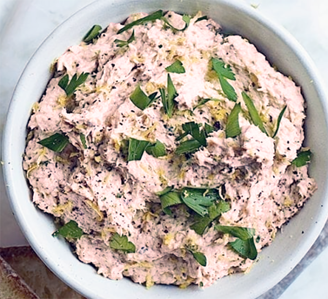 smoked mackerel pâté in a ramekin garnished with flat-leaf parsley