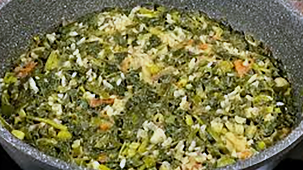 armenian spinach and rice stew served in a granite bowl
