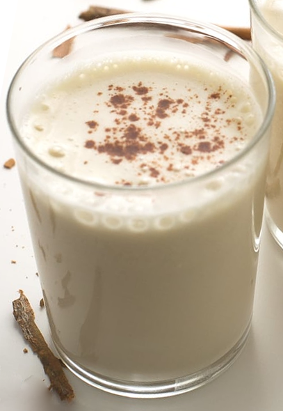 Spanish almond horchata in a glass with a sprinkling of ground cinnamon