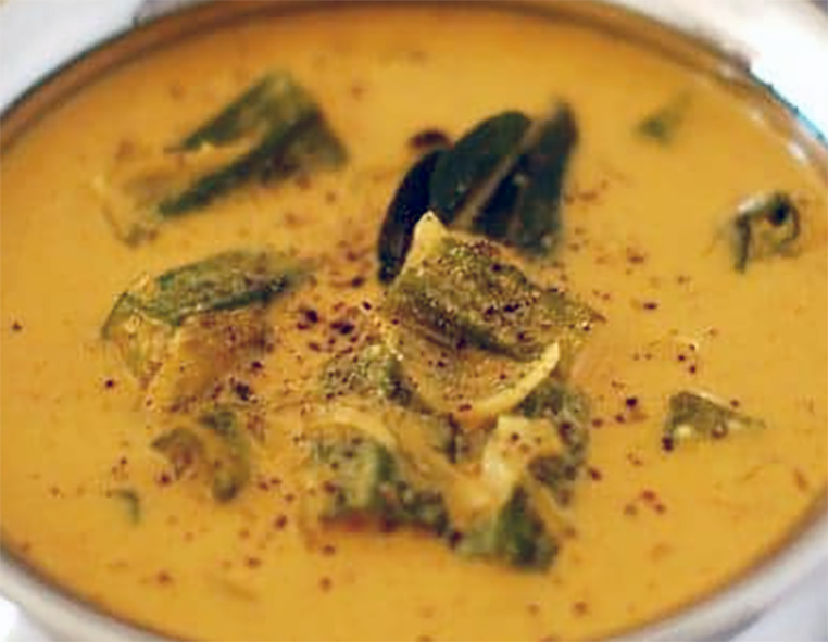 spice okra in coconut milk served in a metal bowl