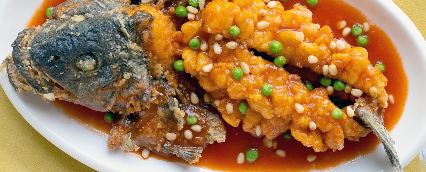 squirrel fish with back opened and the orange vegetable mixture spooned on top</a>