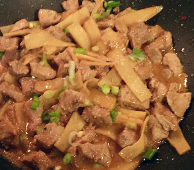 pork and bamboo shoot stir fry in the base of a wok
