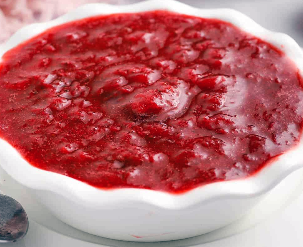 strawberry and raspberry fruit compote in a white bowl