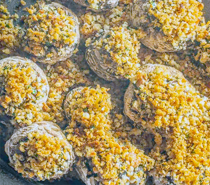stuffed parasol mushroom caps piled on a serving plate