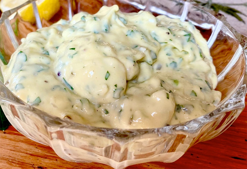 Tartare sauce presented in a fluted glass bowl