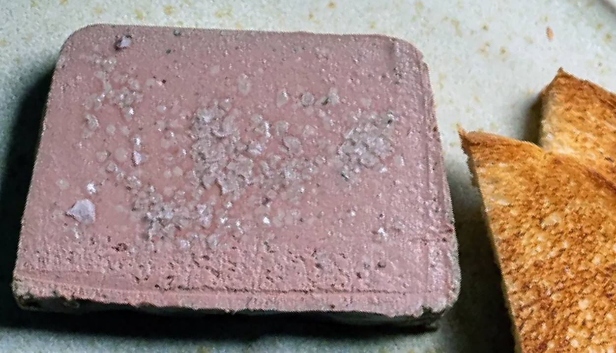 loaf-shaped slice of chicken liver parfait next to some toast