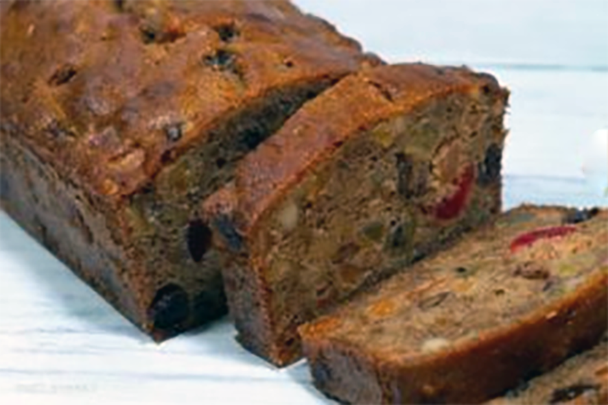 rooibos treacle fruit loaf cake sliced on a wooden board