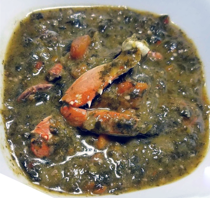 Trinidadian crab and callaloo served in a white bowl