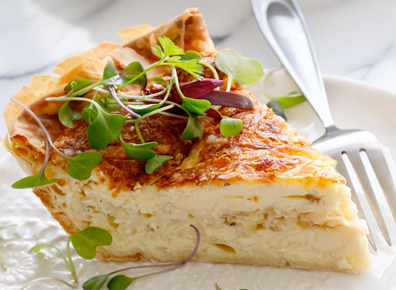 slice of vegetarian quiche on a plate with a fork