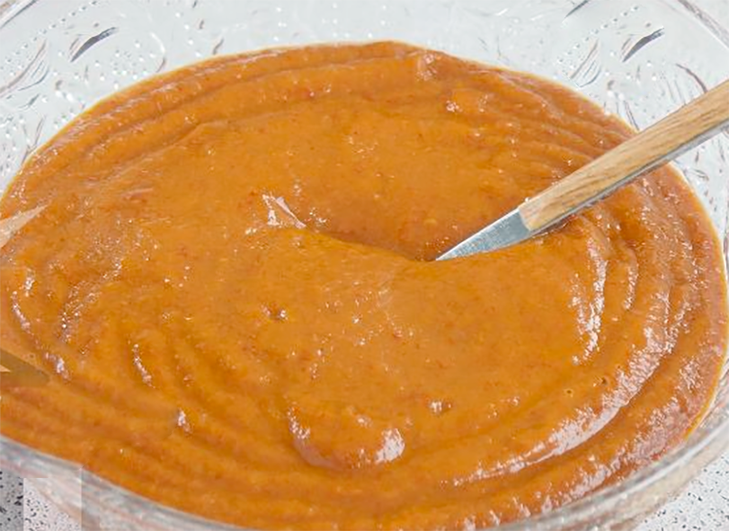 vizcaina chilli sauce served in a glass bowl with a spoon