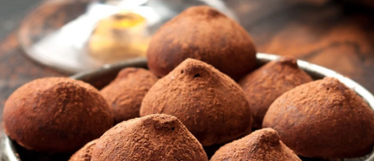 cocoa dusted whiskey truffles in a steel bowl