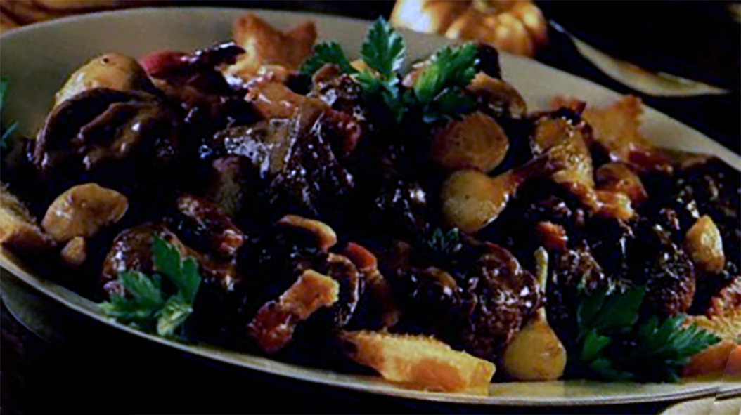 stew of wild boar, mushrooms and chestnuts in an earthenware dish
