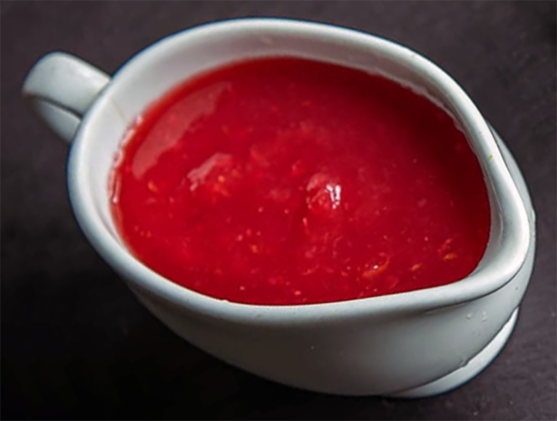 Wild cranberry sauce in a white sauce boat