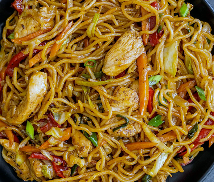 yakisoba of noodles, pork and vegetables stir-fried in a wok